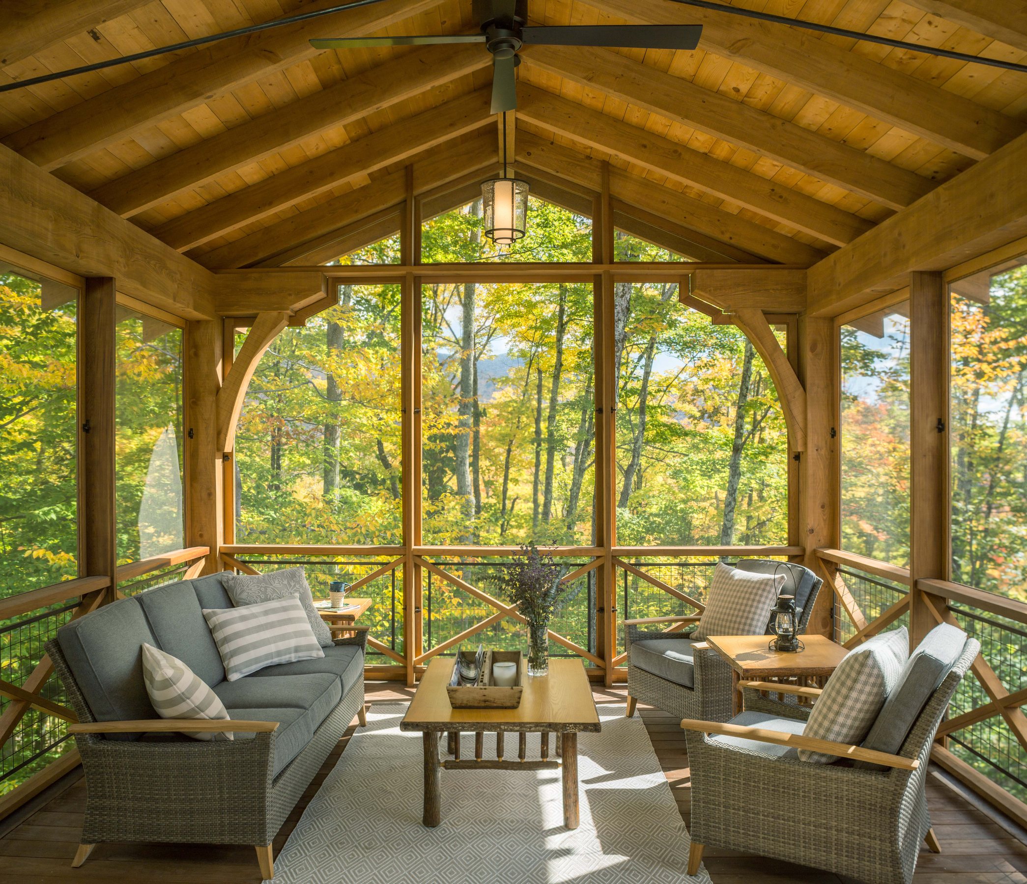 Timber-framed screened room opening to Vermont woodland